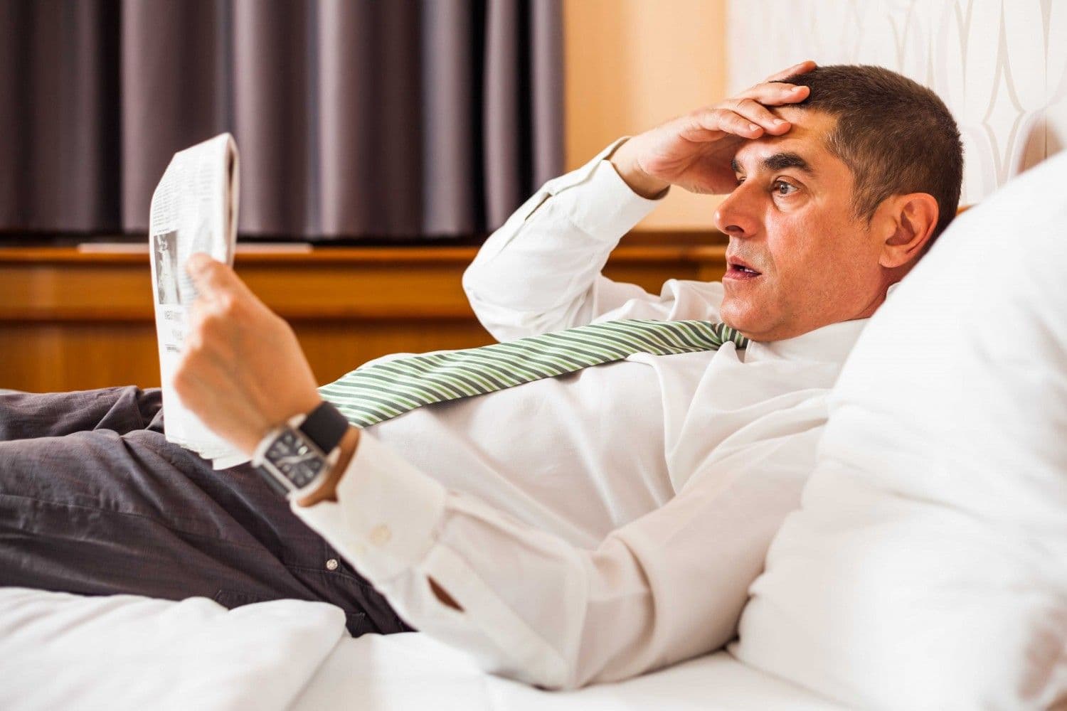 A man reading something shocking in the newspaper. (CoinDesk Archives)